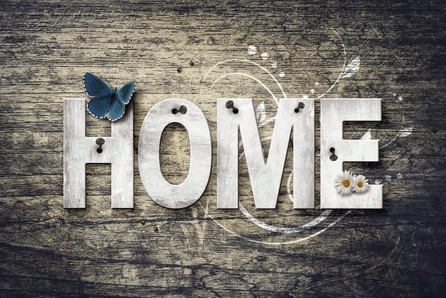 Grey decal with HOME written on it and blue butterfly