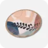 A Round Wooden Decorative Bowl with a leaf pattern, the primary colours are blue, brown dark blue, subtle orange and beige
