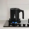 Bialetti Tuttocrema Manual Milk Frother on a gas hob