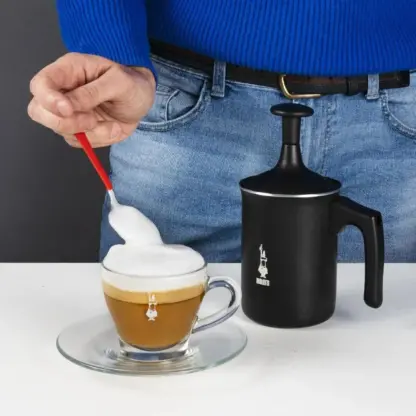 Bialetti Tuttocrema Manual Milk Frother with coffee cup and milk foam on top