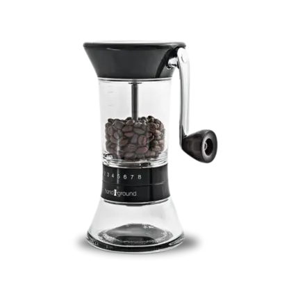 Black Handground coffee grinder filled with beans front view.