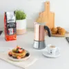 Bialetti Venus Copper Moka Pot on couter with cup of espresso, waffels and bag of perfetto koga ground coffee