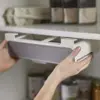Under Shelf Spice Rack being fitted under shelf