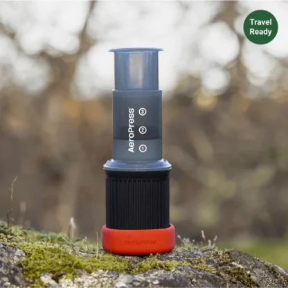 AeroPress Go Travel Coffee Maker outdoors on a rock