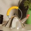 1 Litre Alessi Michael Graves Kettle with yellow handle on table top