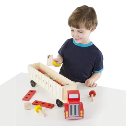 Child playing with Melissa & Doug Big Rig Building Truck Wooden Play Set on table