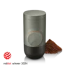Minipresso GR2 Coffee Maker with a small mount of coffee grinds and reddot logo with the text "reddot winner 2024