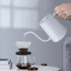 Pour Over Kettle With Digital Temperature Control White pouring water into a pour over filter.