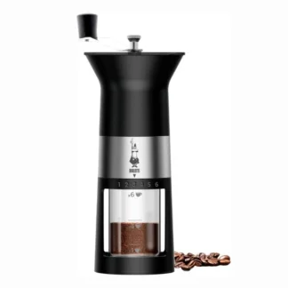 Frontal view of Bialetti Manual Coffee Grinder with some coffee beans on the side.