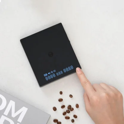 Black Mirror Mini Coffee Scale – Ultra-Thin Precision for Espresso & Pour-Over digital display with coffee beans in the foreground