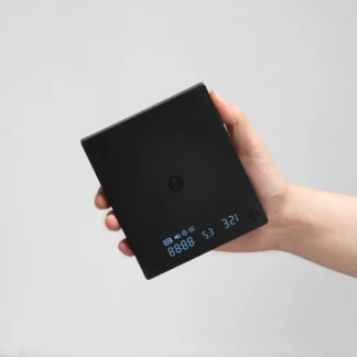 Black Mirror Mini Coffee Scale – Ultra-Thin Precision for Espresso & Pour-Over held i hand to show the compactness of the scale