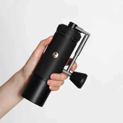 Chestnut S3 Portable Manual Coffee Grinder held in a persons hand showing the compact design
