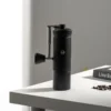 Chestnut S3 Portable Manual Coffee Grinder on table with handle folded