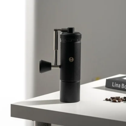 Chestnut S3 Portable Manual Coffee Grinder on table with handle folded