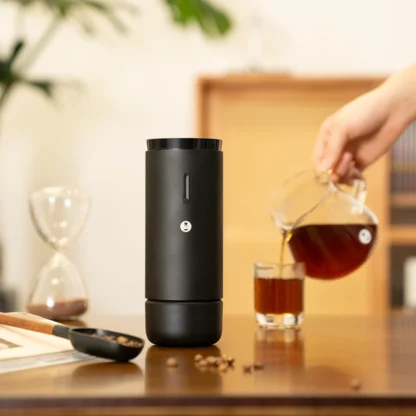 Whirly 01S Portable Electric Coffee Grinder with coffee beans and coffee being poured
