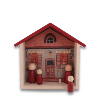 Daisy House Play Set front on view of wooden toy house with on peg doll in the fore ground